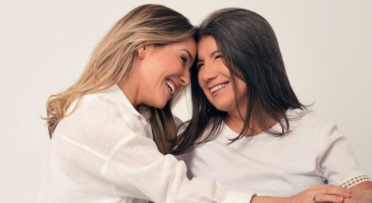 Mother and daughter laughing together while opening a Mother’s Day gift in 2025